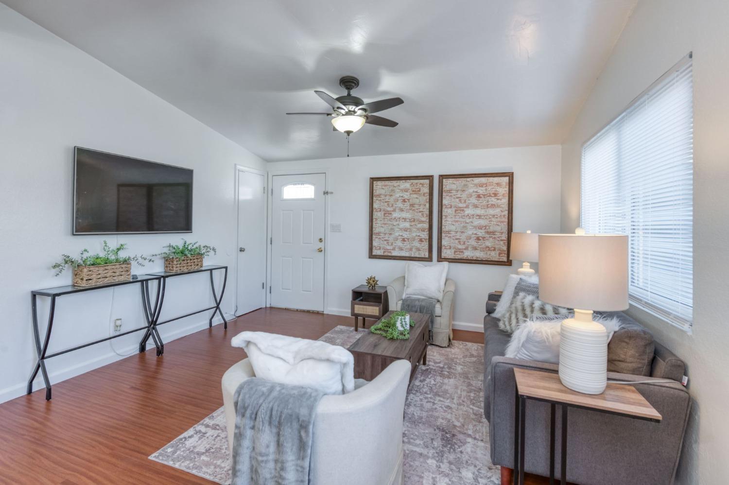 2607 Crescent Avenue Clovis, CA 93612 - Photo 8 of 26 a living room with furniture a window and a flat screen tv