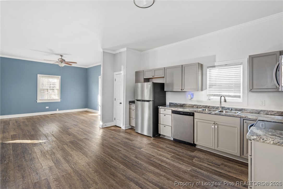 107 North 12th Street Erwin, NC 28339 - Photo 11 of 40 a kitchen with granite countertop a refrigerator stove and sink