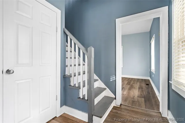 a view of staircase with white walls and a window
