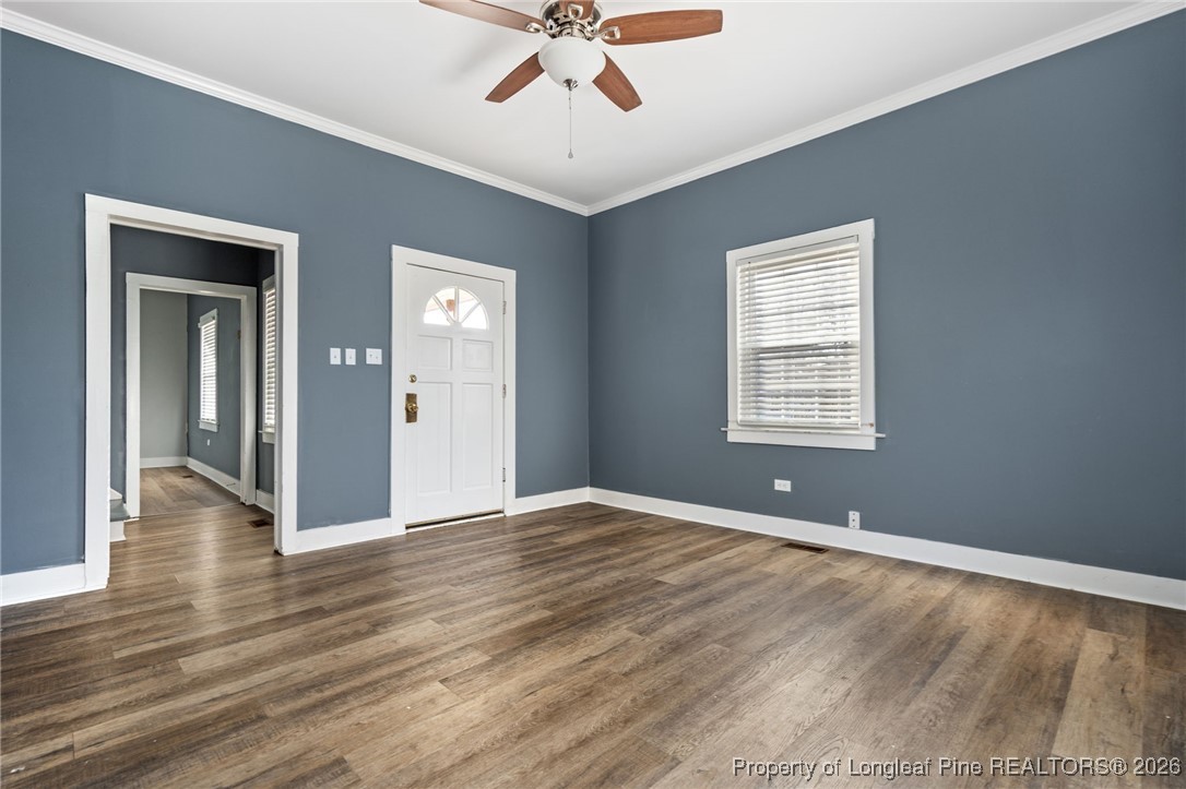 107 North 12th Street Erwin, NC 28339 - Photo 35 of 40 a view of an empty room with wooden floor and a window