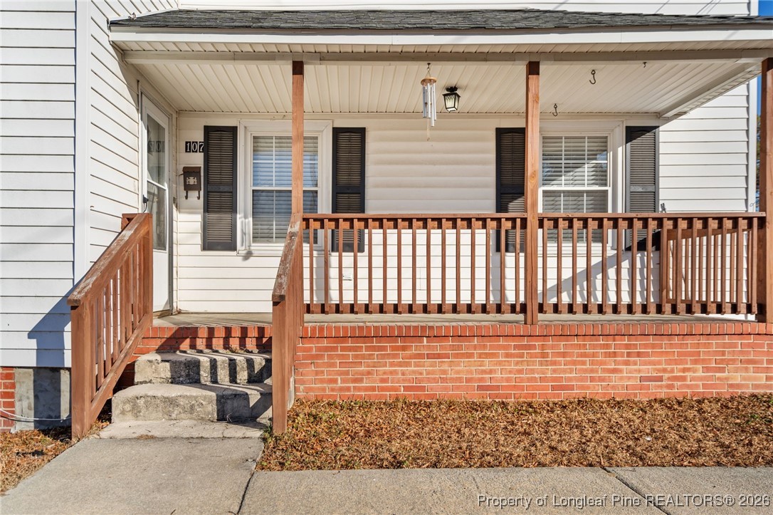 107 North 12th Street Erwin, NC 28339 - Photo 4 of 40 a view of a brick house with wooden floor and fence