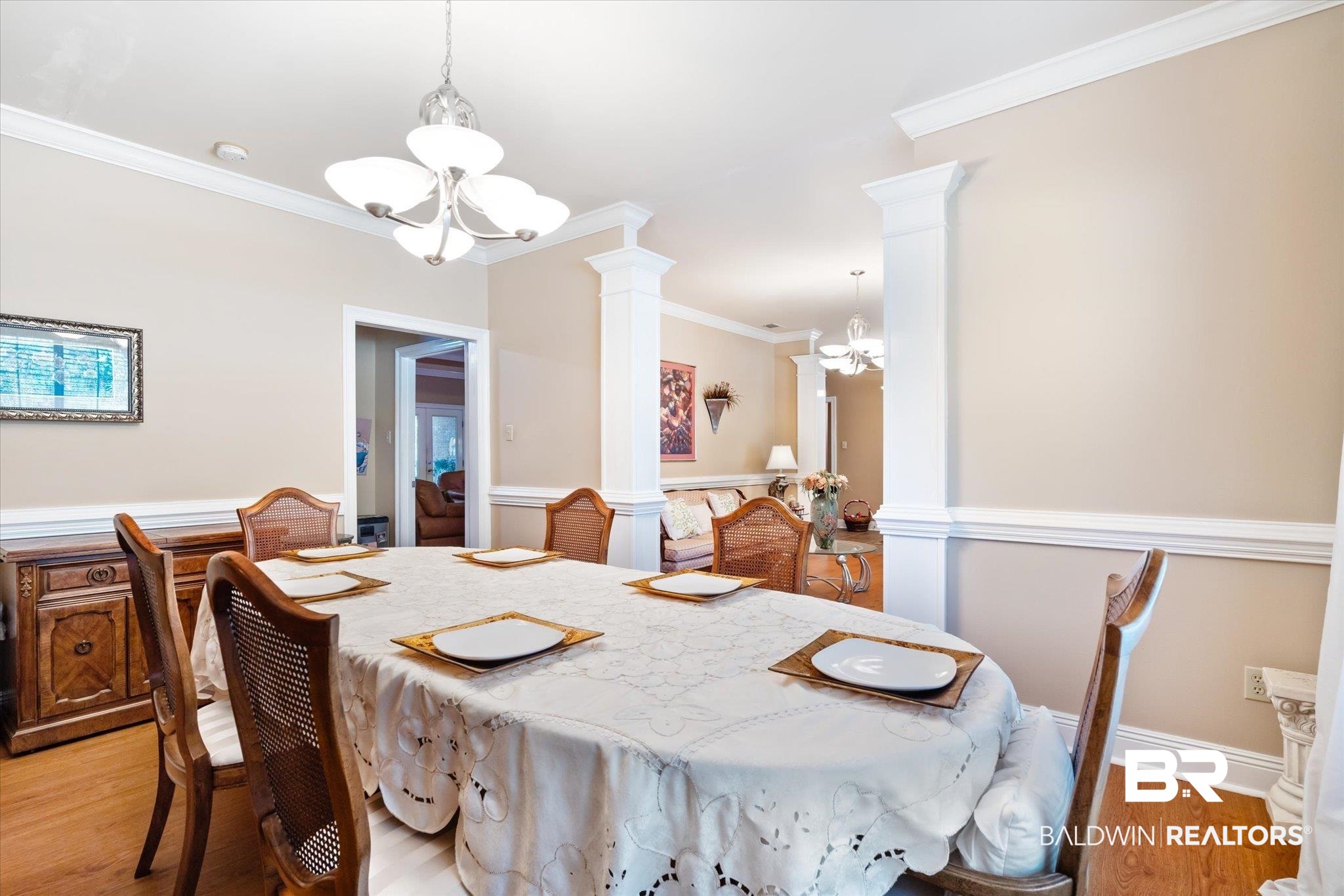 2400 Waterford Road Semmes, AL 36575 - Photo 5 of 30 Dining area featuring a chandelier, ornate columns, ornamental molding, and light wood-style floors