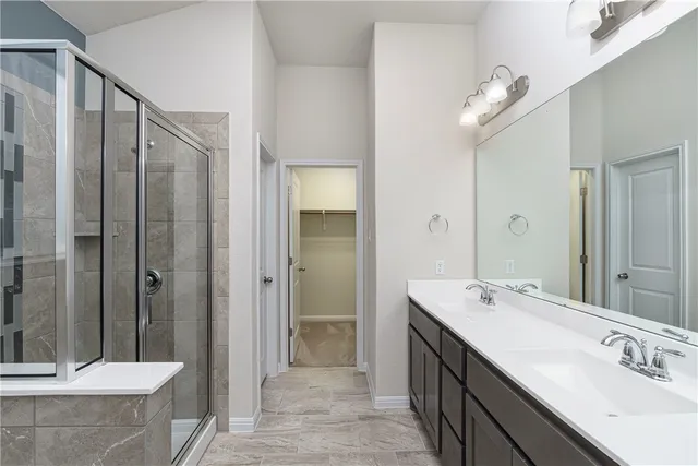 a spacious bathroom with a shower sink mirror and double