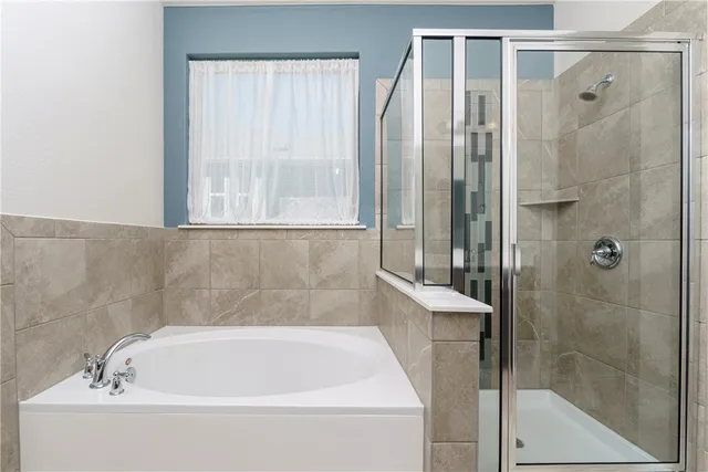 a bathroom with a bathtub and shower