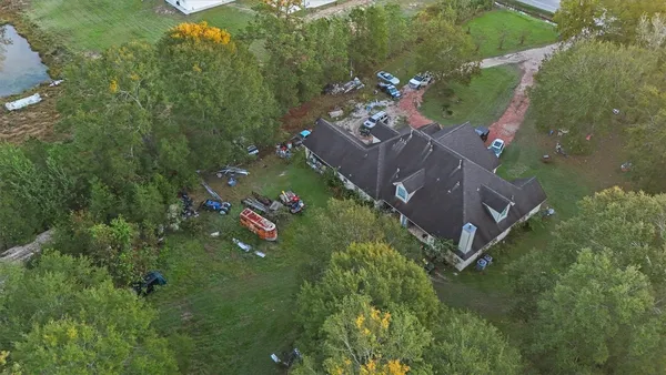 an aerial view of a house with a yard