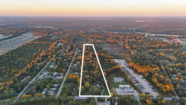 an aerial view of residential houses with city view