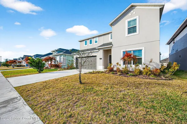 a view of a house with backyard and sitting area