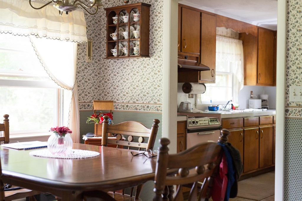 55 Birch Meadow Road Merrimac, MA 01860 - Photo 4 of 7 a kitchen with a sink a stove and chairs