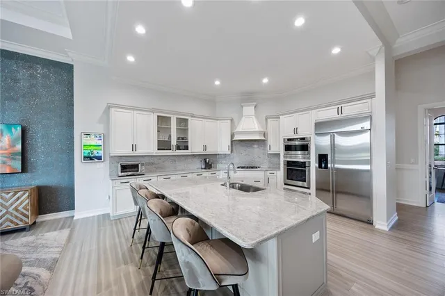a kitchen with cabinets and stainless steel appliances