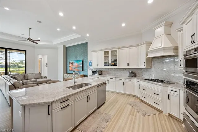 a kitchen with a sink stove and cabinets