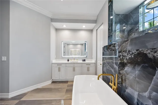 a view of a hallway with wooden floor and cabinets