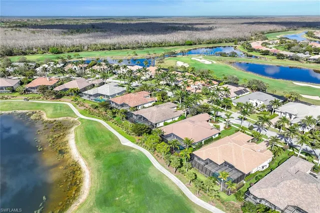 a living room with patio furniture and a large window