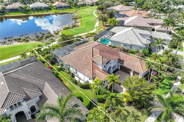 an aerial view of a house with a lake view