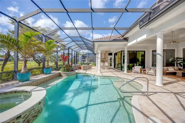 a living room with furniture a flat screen tv and a floor to ceiling window