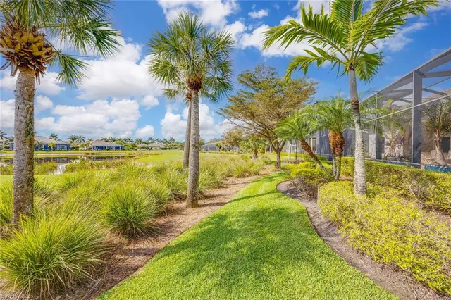 a front view of a house with yard swimming pool and outdoor seating