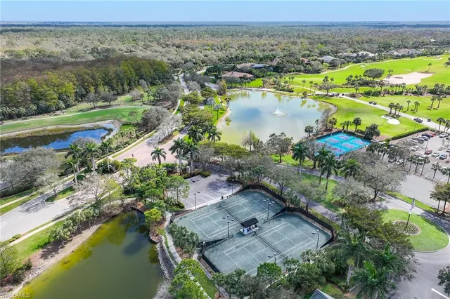 a view of a lake with boats and trees in the background