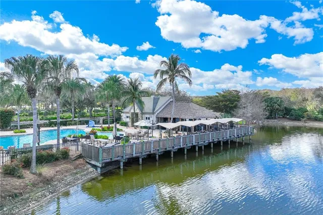 a front view of a house with a yard and fountain