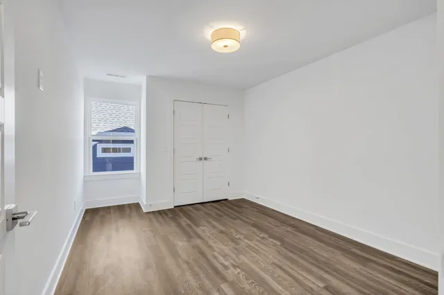a view of room with window and hardwood floor