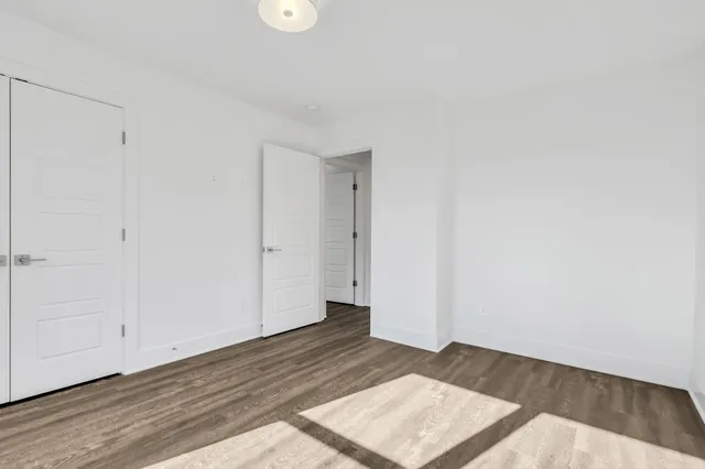 a view of a room with wooden floor