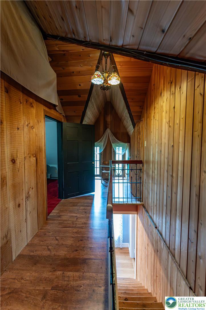 2485 Hieter Road Quakertown, PA 18951 - Photo 52 of 97 Natural wood paneling adorns this cozy hallway with a classic chandelier.
