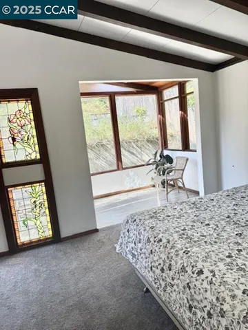 a bed sitting in a room next to a window