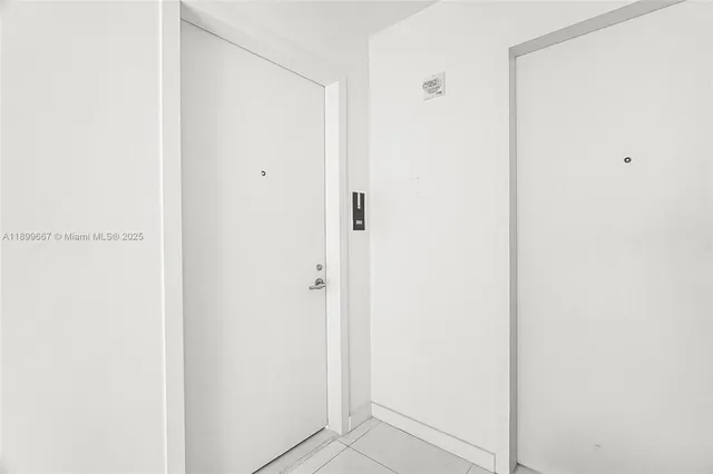 a living room with furniture and floor to ceiling windows