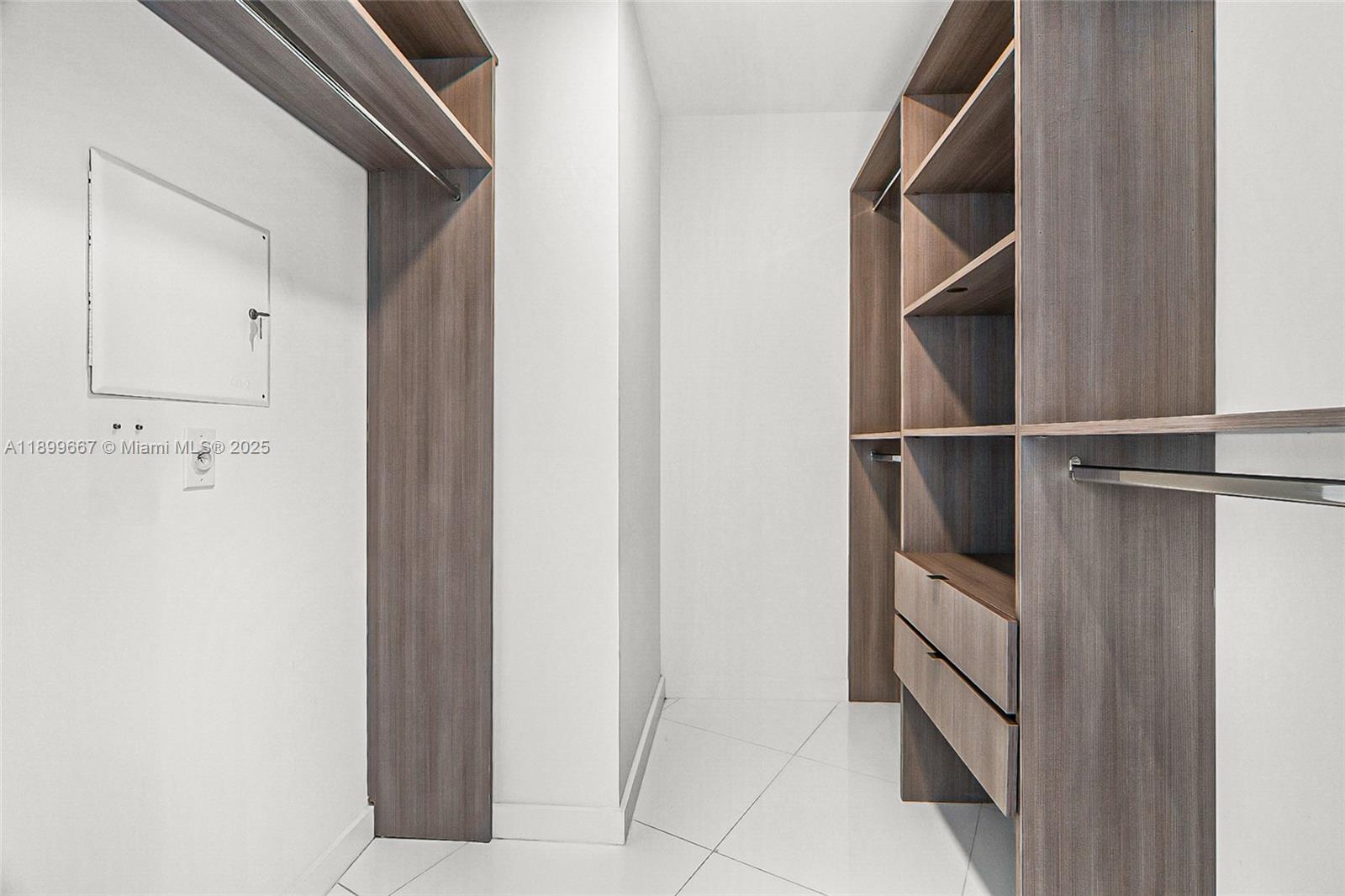 851 Northeast 1st Avenue, Unit 2802 Miami, FL 33132 - Photo 14 of 59 a view of walk in closet with empty racks