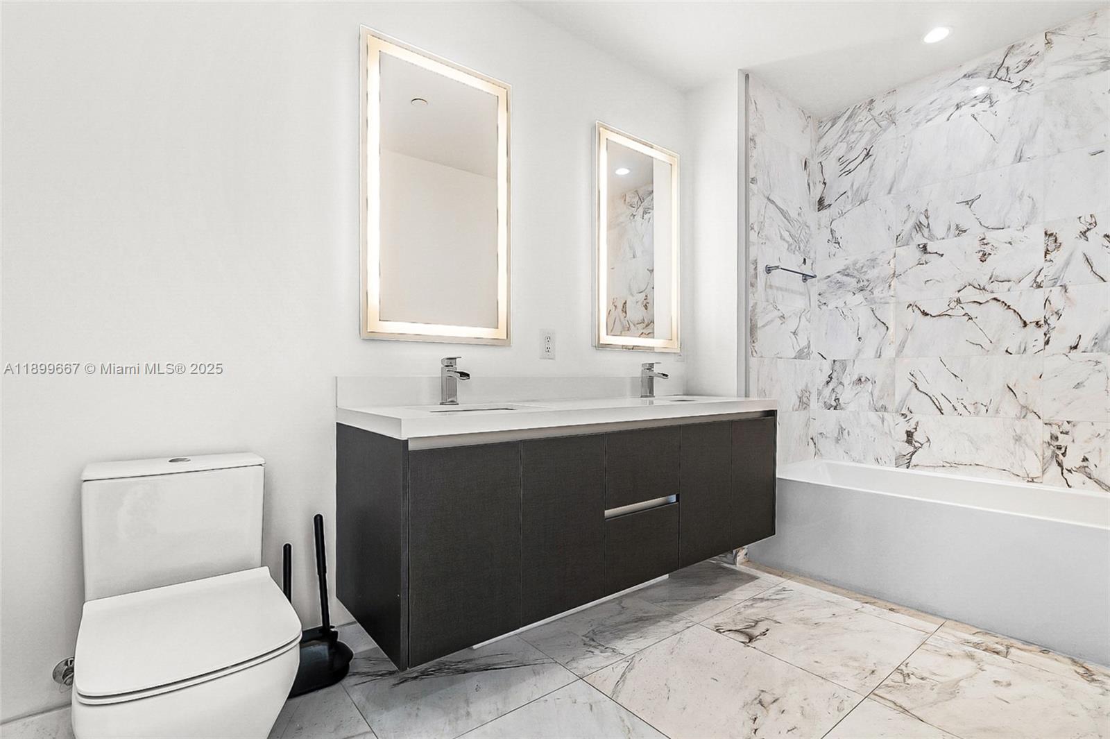 851 Northeast 1st Avenue, Unit 2802 Miami, FL 33132 - Photo 15 of 59 a bathroom with a sink a toilet and shower