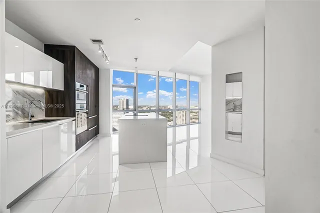 a kitchen with stainless steel appliances a refrigerator and a sink