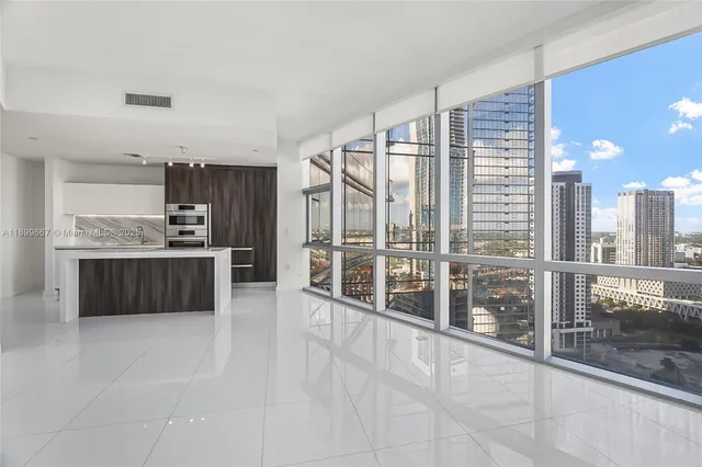 a very nice looking room with a large window and kitchen view