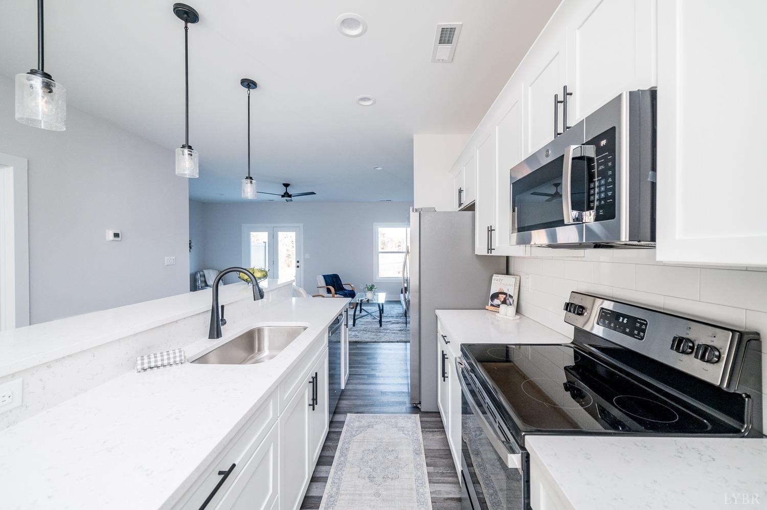 71 Allure Drive Rustburg, VA 24588 - Photo 12 of 56 a kitchen with stainless steel appliances granite countertop a sink a stove and a refrigerator