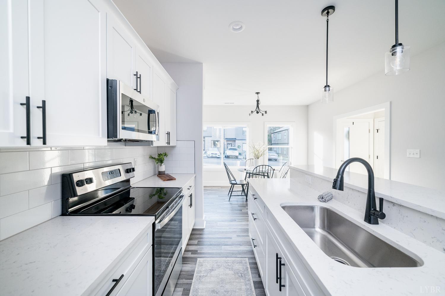 71 Allure Drive Rustburg, VA 24588 - Photo 13 of 56 a kitchen with stainless steel appliances a sink a stove top oven a counter space and cabinets