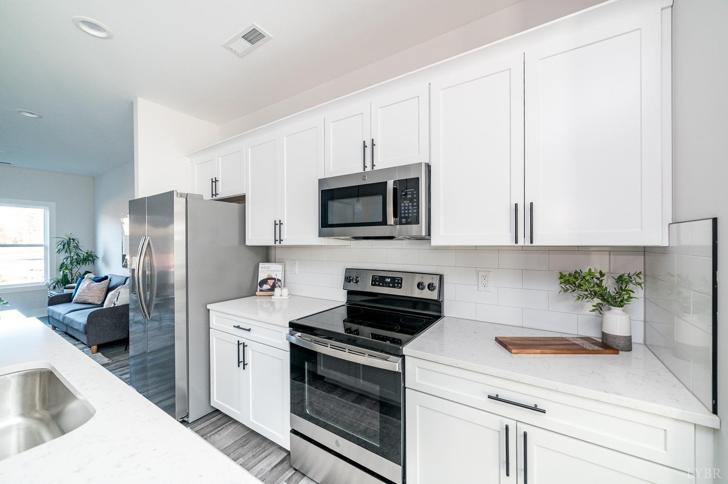 71 Allure Drive Rustburg, VA 24588 - Photo 14 of 56 a kitchen with stainless steel appliances white cabinets and a stove