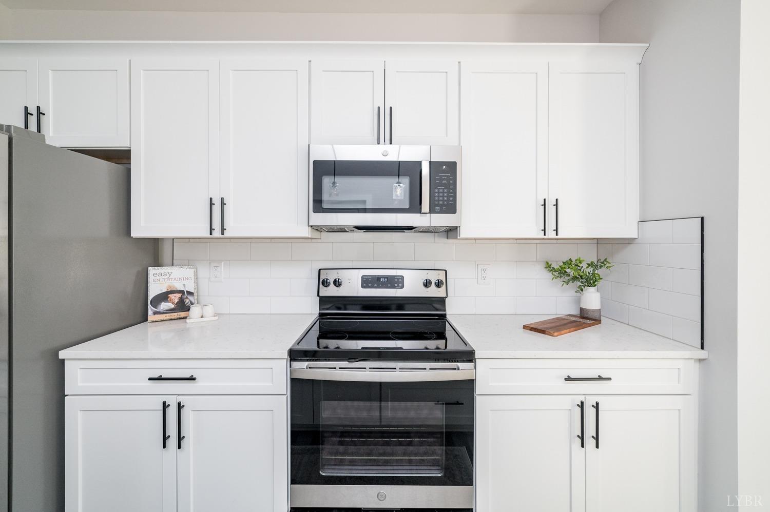 71 Allure Drive Rustburg, VA 24588 - Photo 17 of 56 a kitchen with granite countertop a stove a sink and a microwave