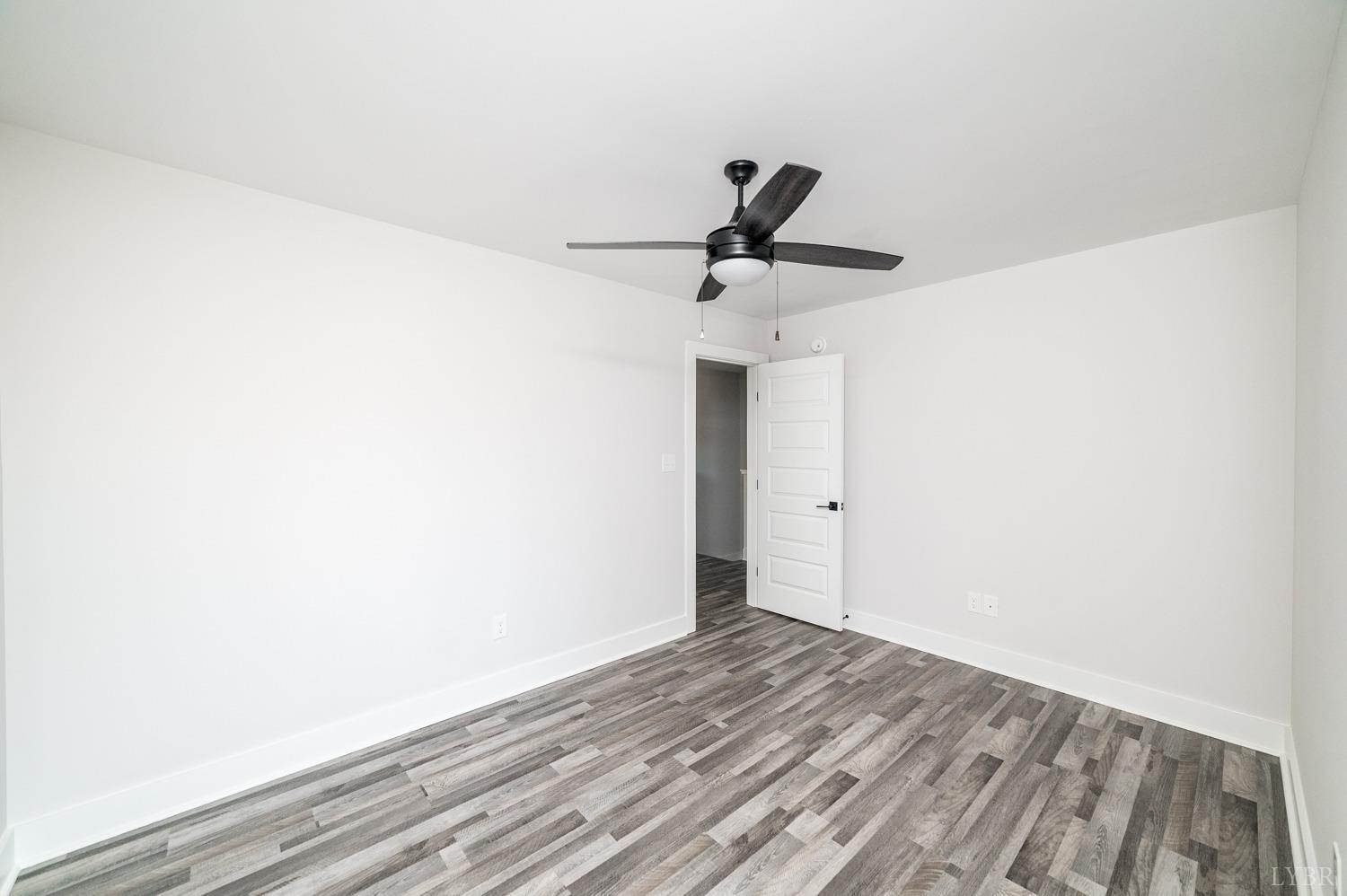71 Allure Drive Rustburg, VA 24588 - Photo 36 of 56 a view of a room with wooden floor and a ceiling fan