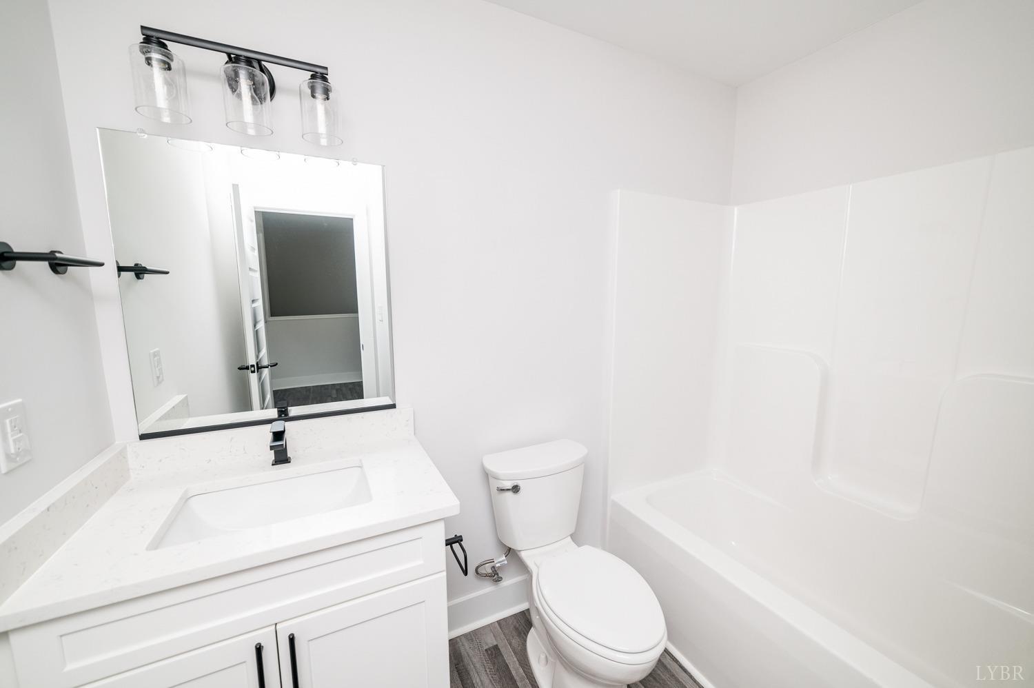 71 Allure Drive Rustburg, VA 24588 - Photo 39 of 56 a white toilet sitting next to a bathroom sink