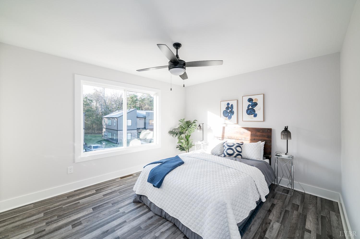 71 Allure Drive Rustburg, VA 24588 - Photo 41 of 56 a bedroom with a bed chandelier and a window