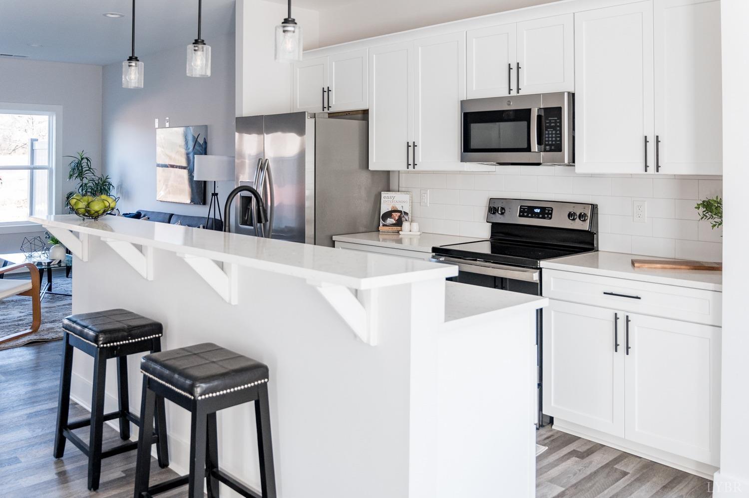 71 Allure Drive Rustburg, VA 24588 - Photo 46 of 56 a kitchen with stainless steel appliances a stove a sink a microwave and a refrigerator