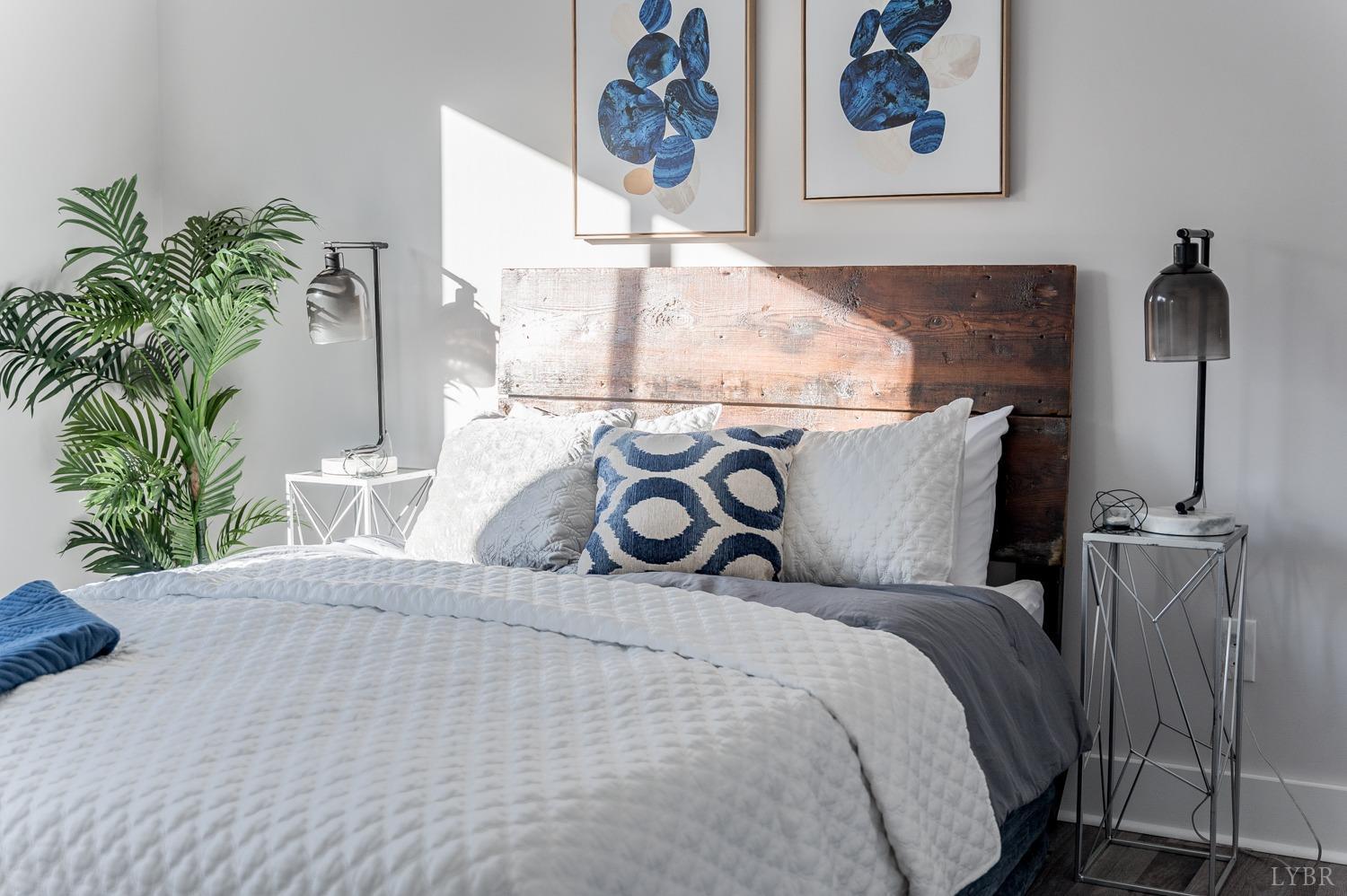 71 Allure Drive Rustburg, VA 24588 - Photo 53 of 56 a bed sitting in a bedroom and painting on the wall