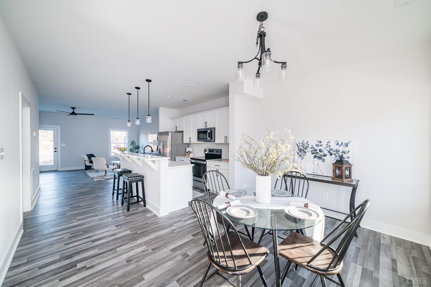 71 Allure Drive Rustburg, VA 24588 - Photo 9 of 56 a view of a dining room with furniture and wooden floor