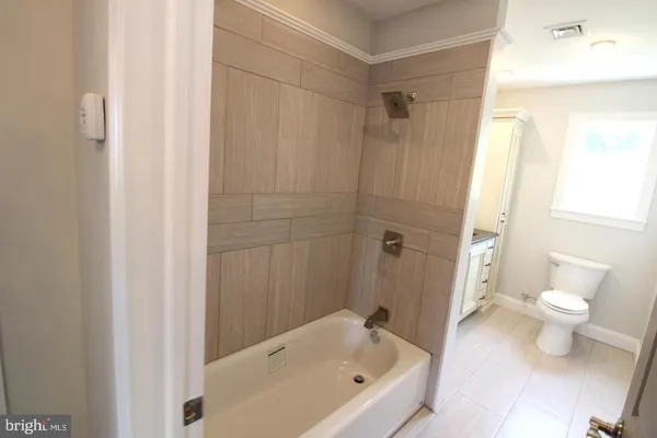 a bathroom with a bathtub and a toilet