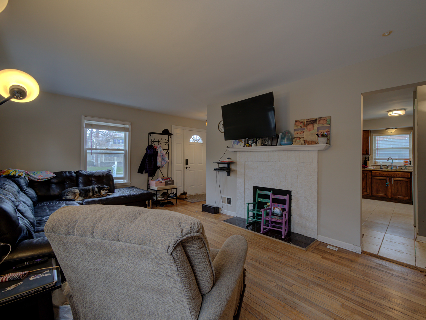 1717 183rd Street Homewood, IL 60430 - Photo 3 of 12 a living room with furniture a fireplace and a flat screen tv