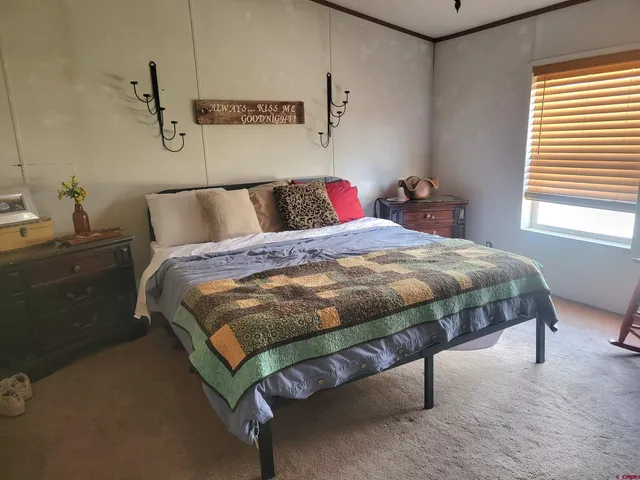 a bedroom with a bed and window