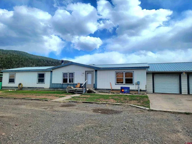 a house view with a sitting space and garden space