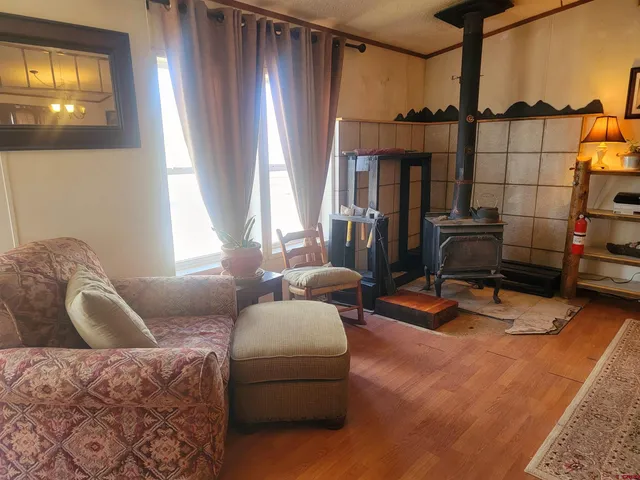 a living room with furniture a flat screen tv and a window