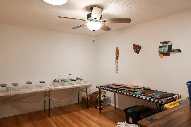 a room with stainless steel appliances a sink a window and wooden floors