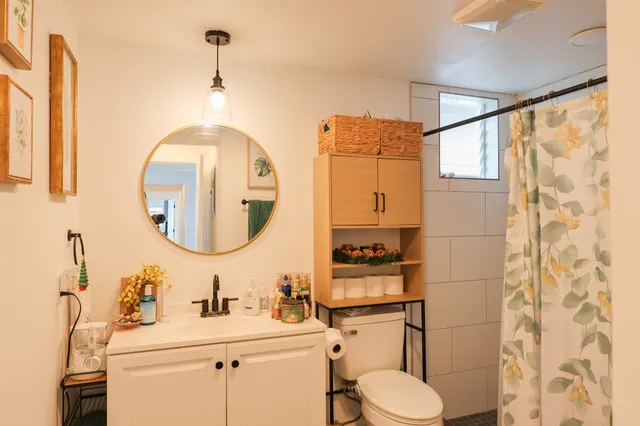 a bathroom with a sink mirror and shower
