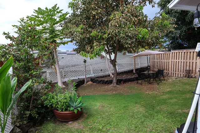 a kitchen with kitchen island a counter space a sink appliances and cabinets