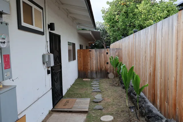a view of a hallway with wooden floor and a window