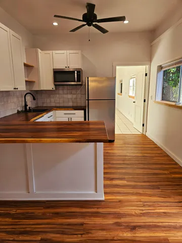 a bathroom with a granite countertop toilet sink and mirror
